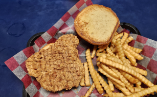 A breaded pork tenderloin sandwich and fries.